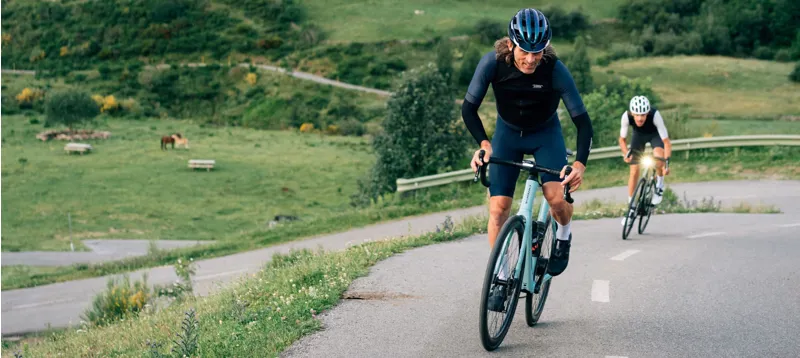 Road Bike Riders Climbing Hill